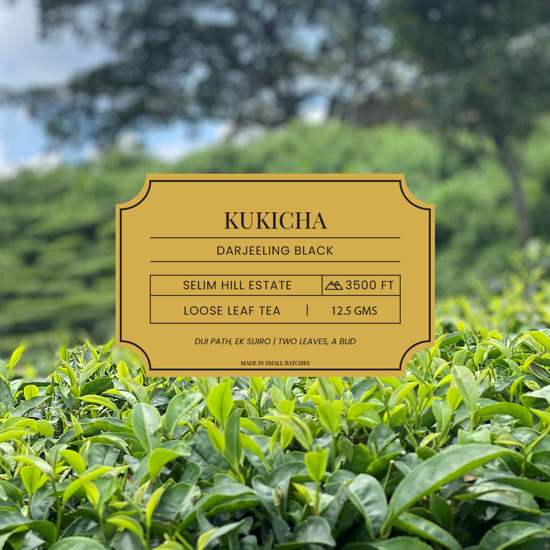 A label of Dorje Kukicha - Japanese Twig tea against a backdrop of tea bushes